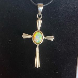Sleeking silver cross pendant with fire opal